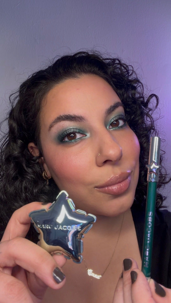 photo of woman holding marc jacobs beauty eye shadow and eyeliner